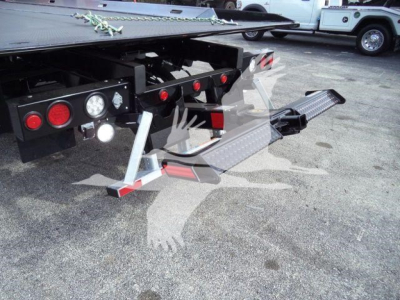 Mack MD6 rollback truck rear showing hydraulic winch, rear bumper, and side step with textured step plates.