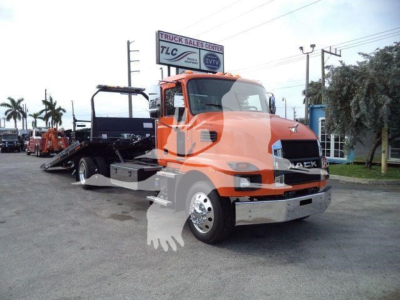 Mack MD6 rollback truck in orange showing front grille and chrome bumper
