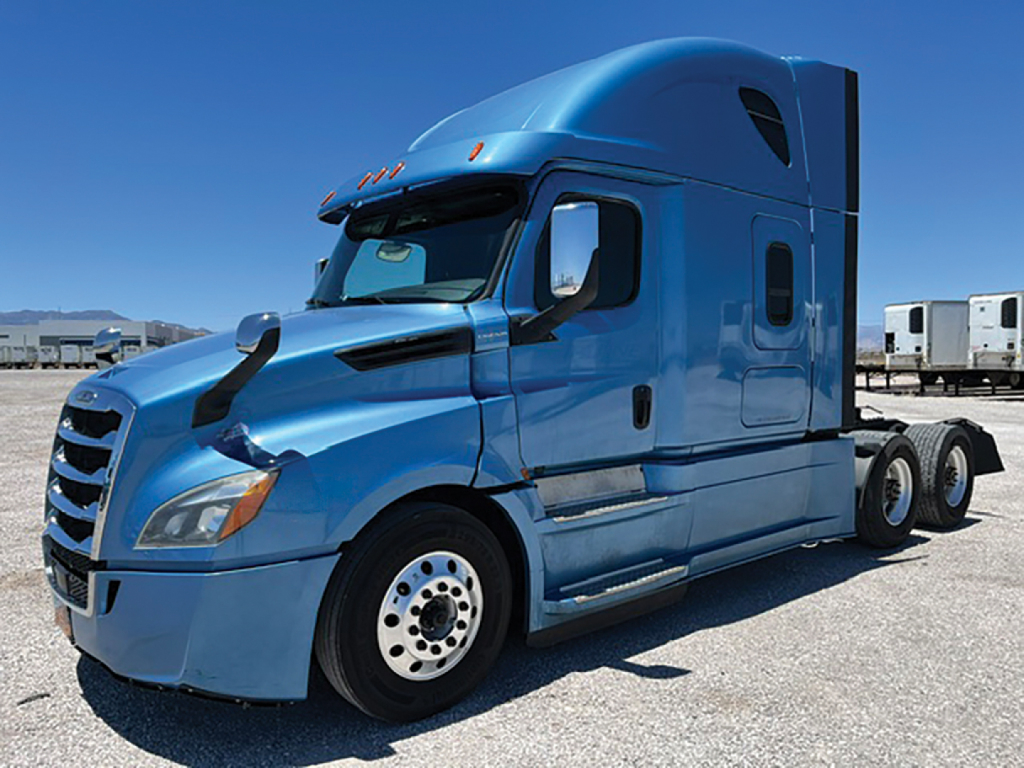 Blue Freightliner Cascadia126 semi-truck tractor cab with stock number plaque and VIN text overlay in image.