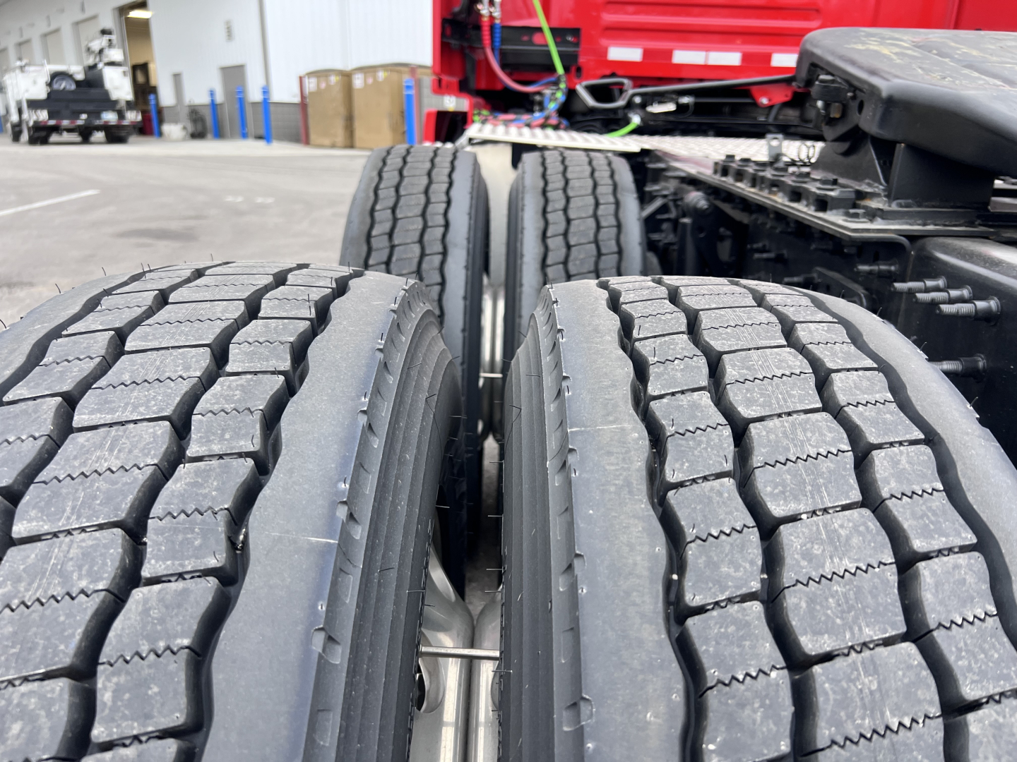 Volvo VNL64T300 truck rear dual-axle tires and chassis showing tread detail and wheel assembly.