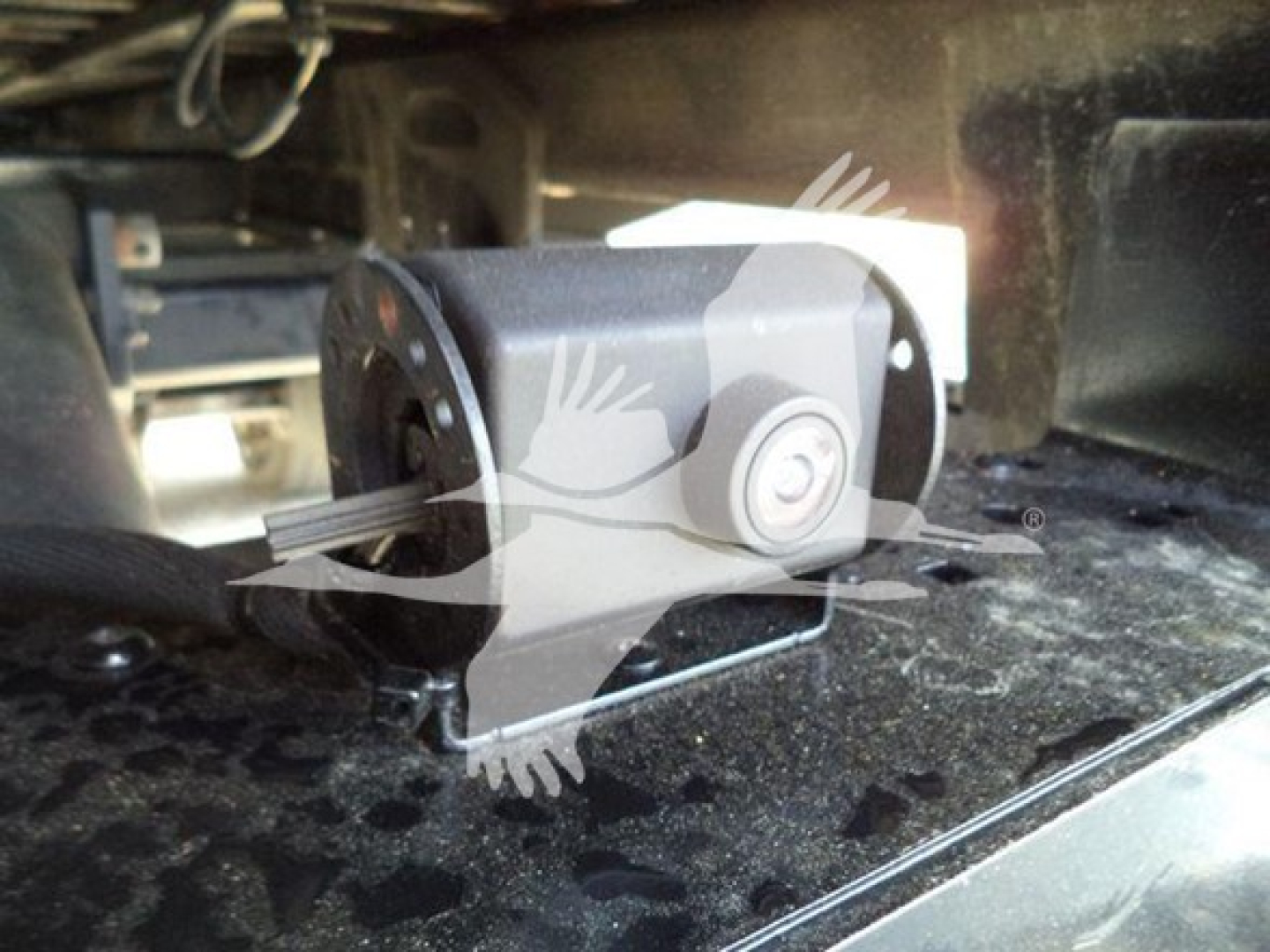 Rear view of a Ford F-600 rollback truck showing a camera or sensor mounted in the cab/bed area.