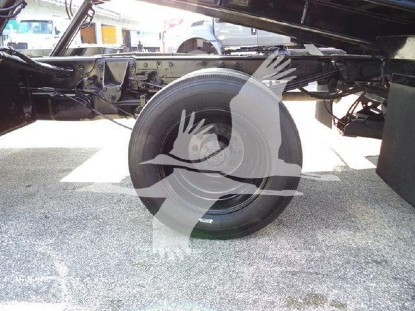 Ford F-Series truck chassis with spare wheel and wheel well visible underframe; no legible text on components.