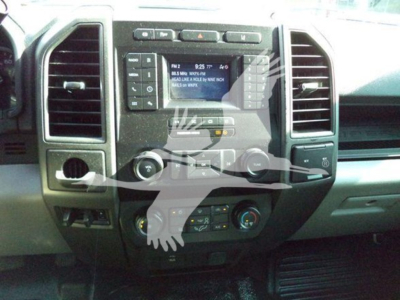 Ford F-Series cabin center stack showing radio, climate controls, and vents.