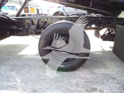 Ford F-Series truck chassis with spare wheel and wheel well visible underframe; no legible text on components.