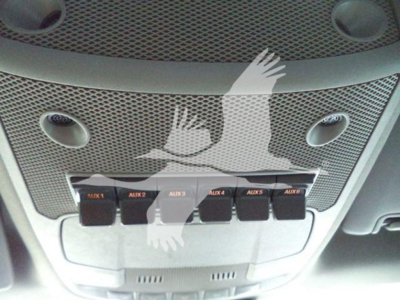 Ford F-Series truck interior overhead console with six AUX switches labeled AUX1 to AUX6 and a perforated grille