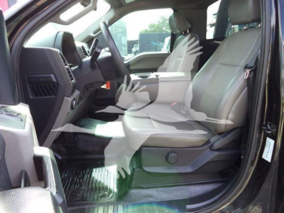 Interior of a Ford F-600 cab showing front seats and dashboard from the driver side.