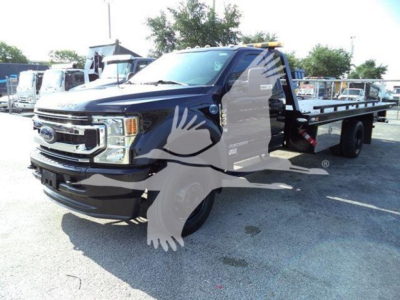 2022 Ford F-600 rollback truck showing front-left view with dual rear wheels and flatbed; VIN 1FDFF6KT2NDA16523 visible.