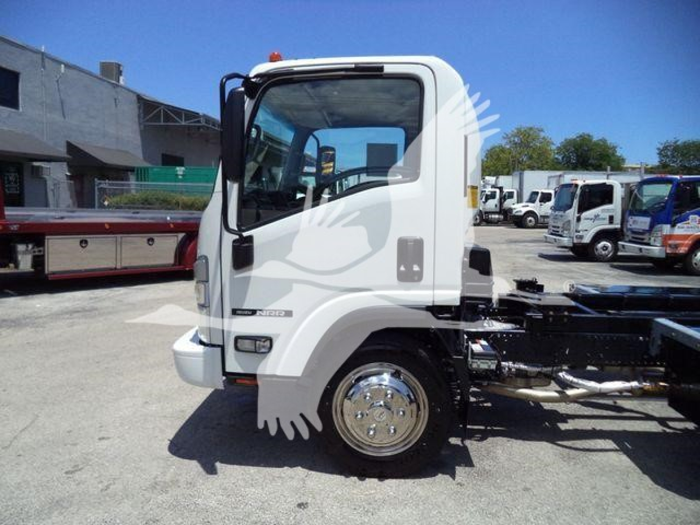 Isuzu NPR/NRR cab from side showing wheel and chassis, with no visible text on side labels.