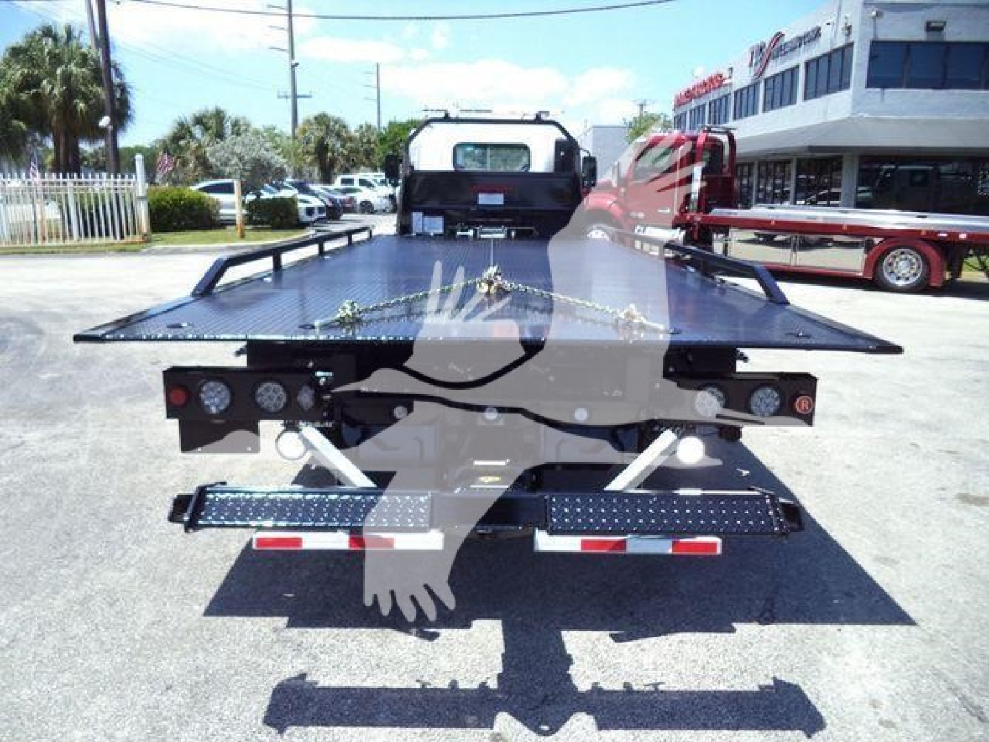Isuzu rollback tow truck flatbed rear showing deck and taillights
