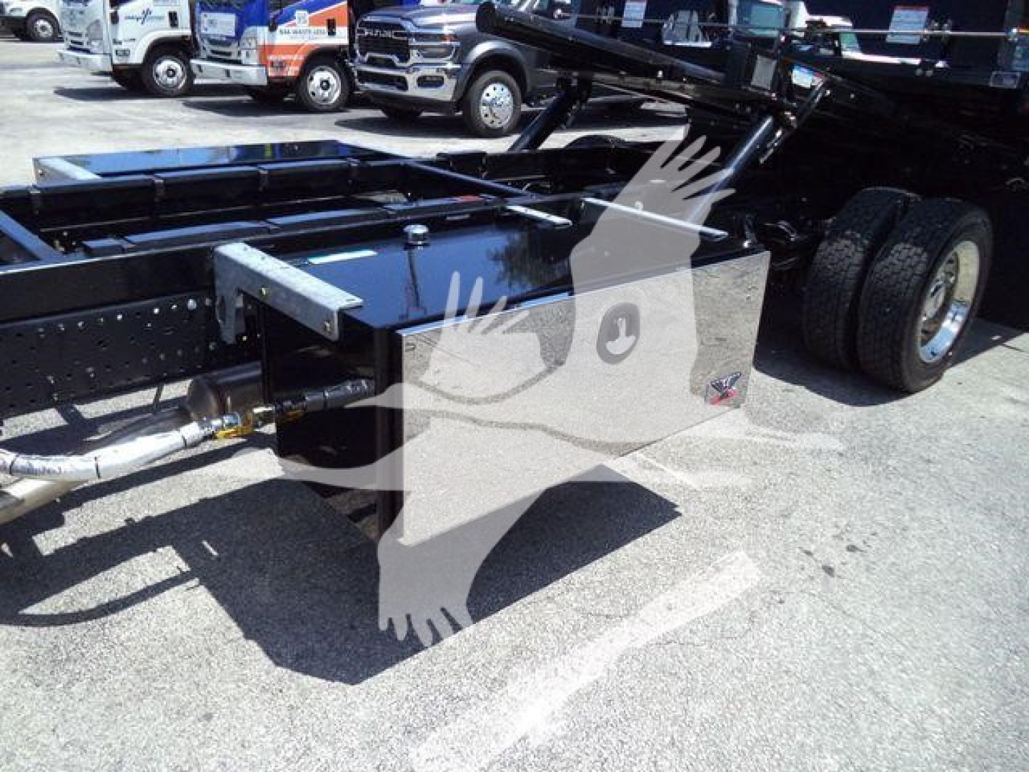 Isuzu NPR rollback truck chassis showing rear frame with storage box and dual rear wheels.