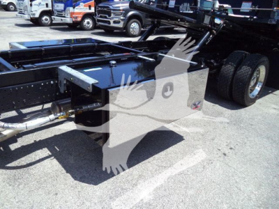Isuzu NPR rollback truck chassis showing rear frame with storage box and dual rear wheels.