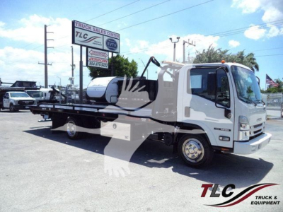 Isuzu NPR rollback tow truck in white with flatbed, side view showing cabin and long bed.