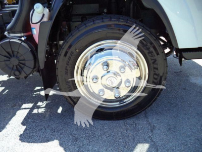 Isuzu NPRR rollback truck front wheel rim and tire with fender and utility components visible.