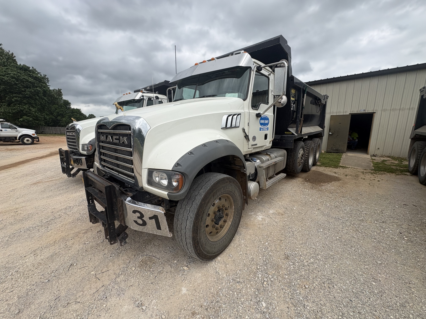 Mack dump truck 2023 GR84F front-left view showing grille, bumper, and front license plate 31.