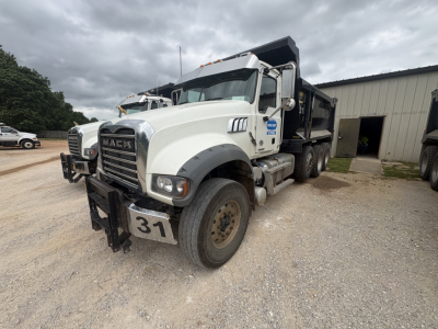 Mack dump truck 2023 GR84F front-left view showing grille, bumper, and front license plate 31.