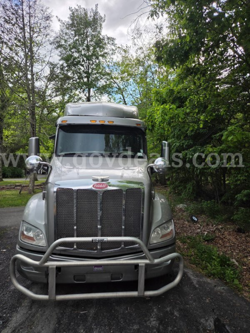 Peterbilt 579 truck front view showing grille guard and bumper, silver exterior, daytime outdoor setting.