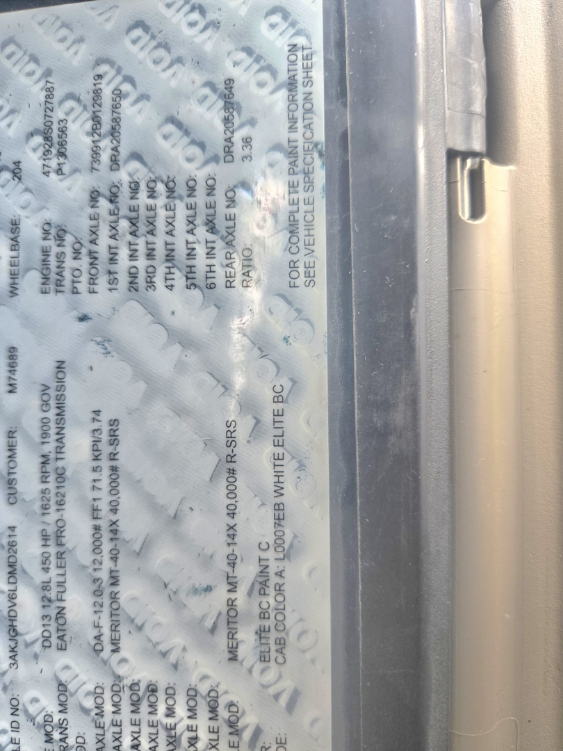 Vehicle data label on Freightliner Cascadia showing paint codes and compliance text; includes numerous small-print warranty and model information in a vertical orientation.