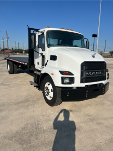 Mack MD6 flatbed truck in white, front and side view with flatbed and dual rear wheels.