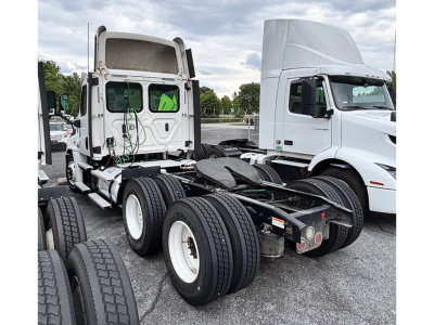 Freightliner Cascadia125 tractor chassis showing rear undercarriage and fifth wheel area with dual rear axles and exposed air lines.
