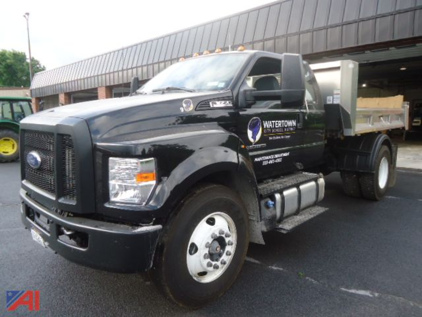 Truck front-left view of a black 2025 Ford F650 Super Duty Roll Off with dump bed, logo reads WATER TOWN SCALE and dump body on chassis.