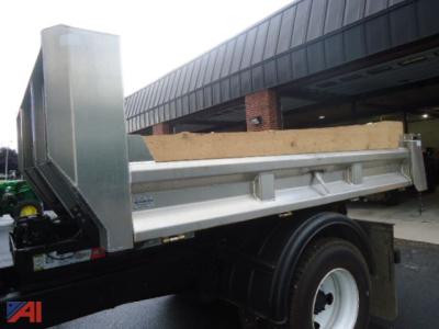 Ford F650 Super Duty roll off truck bed showing side view with silver Hauler bed and black chassis.