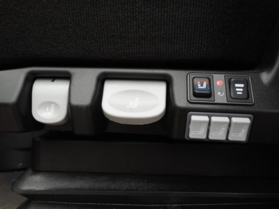 Freightliner Cascadia interior controls: seat adjustment dials, buttons for seats, and window/seat controls visible in cabin.