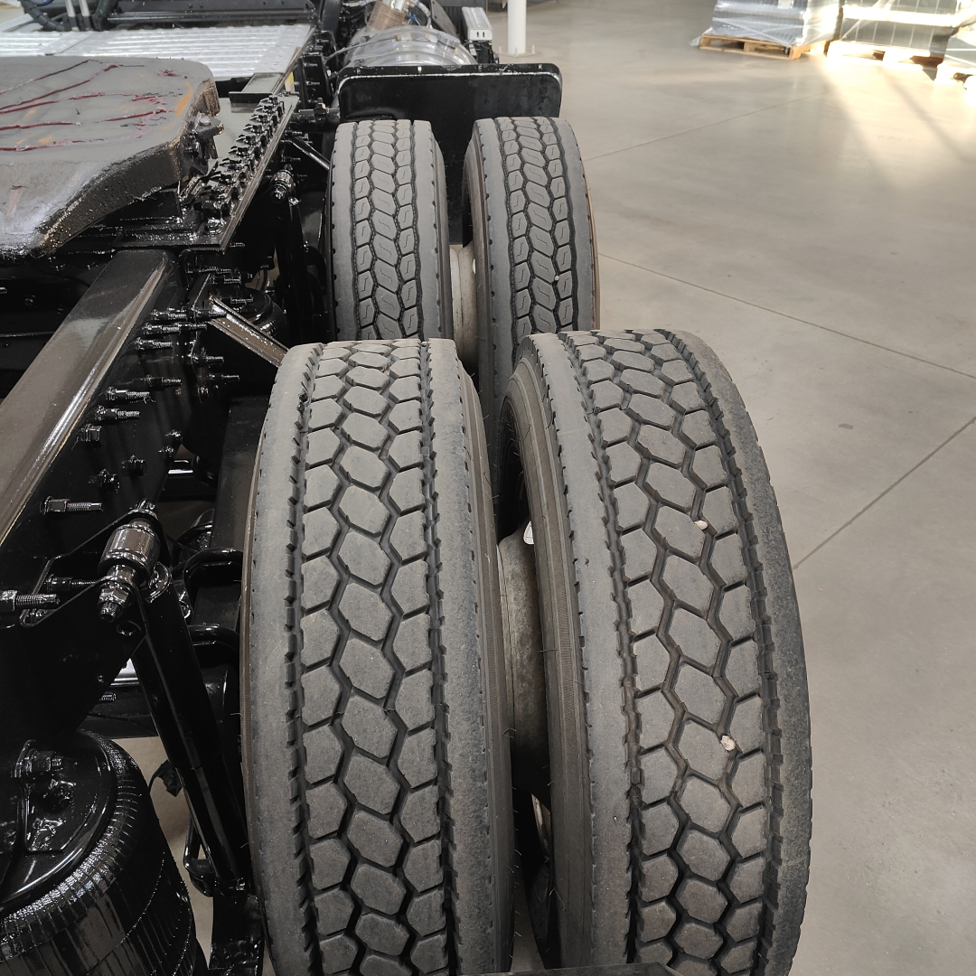 Two rear tandem wheels of a Mack AN64T truck chassis showing dual tires and undercarriage components.