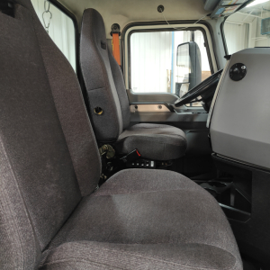 Cab interior of a 2020 Mack AN64T conventional daycab showing driver and passenger seats and dashboard.