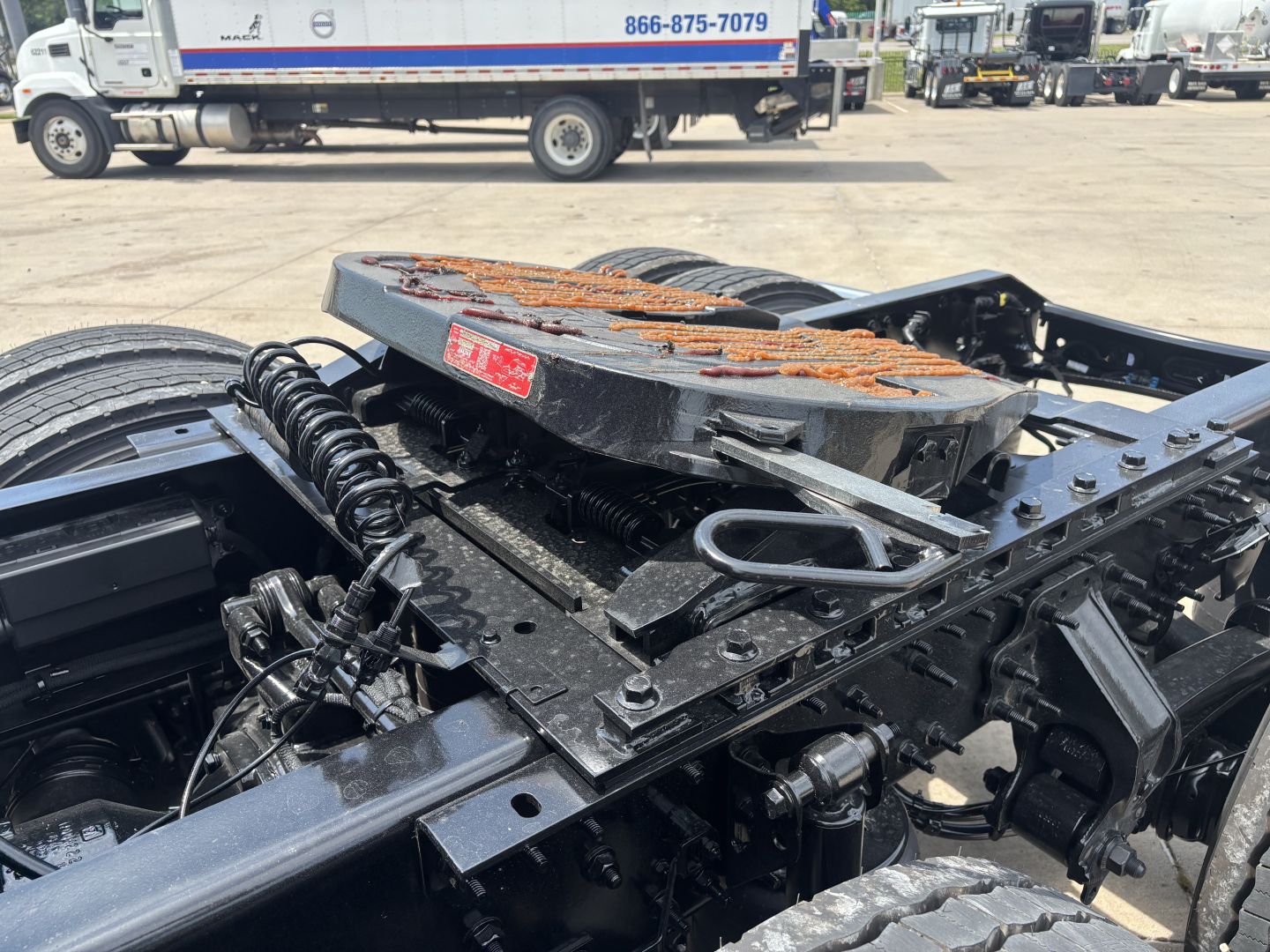 Volvo truck chassis and fifth wheel area showing air lines, springs, and frame components.