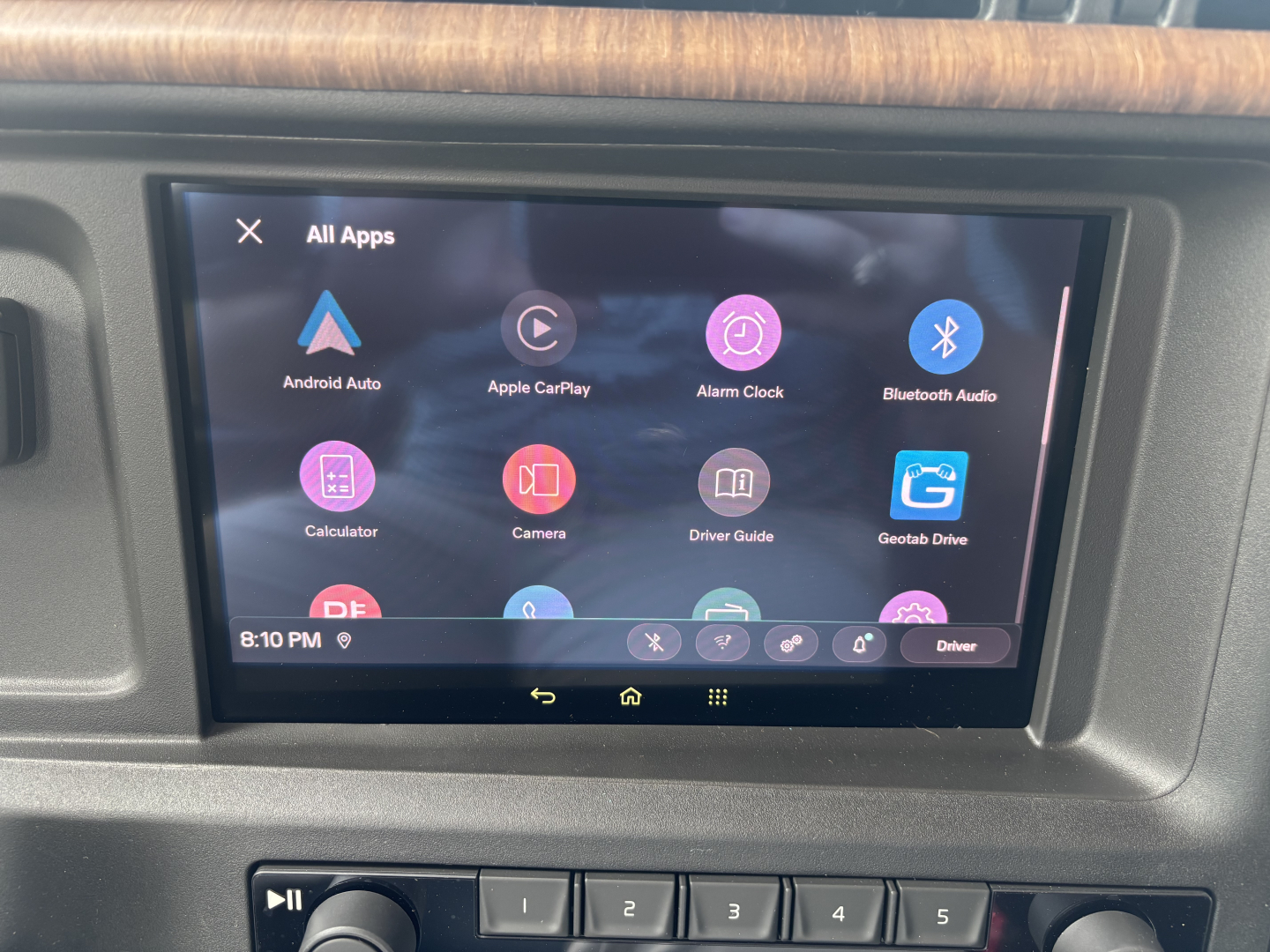 Vehicle infotainment screen showing Android Auto apps in a Volvo VNL interior dash