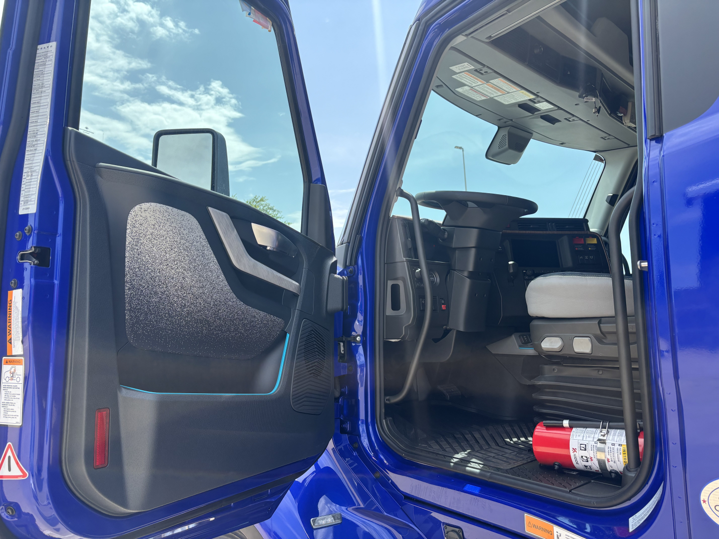 Volvo VNL64T860 truck cab interior door open showing driver seat and dashboard