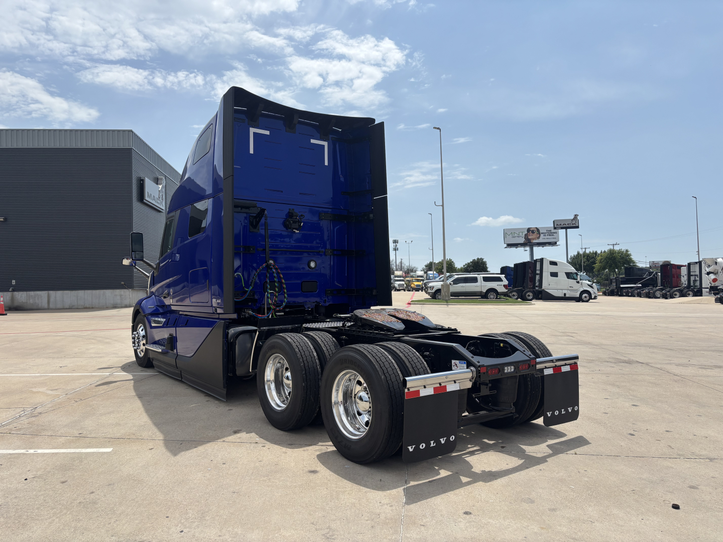 Volvo VNL64T860 tractor cab and chassis rear view showing dual rear axles and fifth-wheel connection