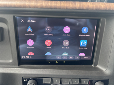Vehicle infotainment screen showing Android Auto apps in a Volvo VNL interior dash