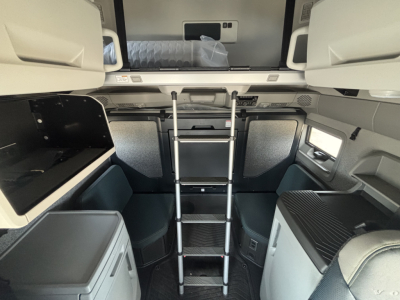Volvo VNL64T860 truck interior: top bunk with ladder, side cabinets, and sleeper area visible