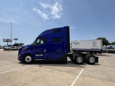 Blue Volvo VNL64T860 tractor-trailer side view showing sleeper cab and attached trailer.