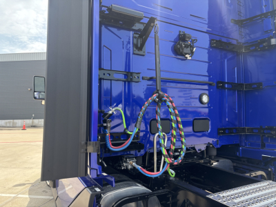 Volvo VNL64T860 cab interior area showing wiring, hoses, and electrical connections near rear of cab.