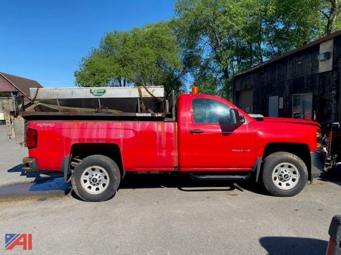 Chevrolet Silverado 3500HD pickup with plow and sander in red side view showing long bed and single cab.