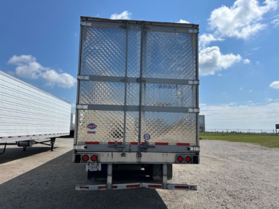 Rear view of a 2020 Utility reefer trailer with diamond plate doors, reflective tape, and dual rear doors; includes bumper and taillights.
