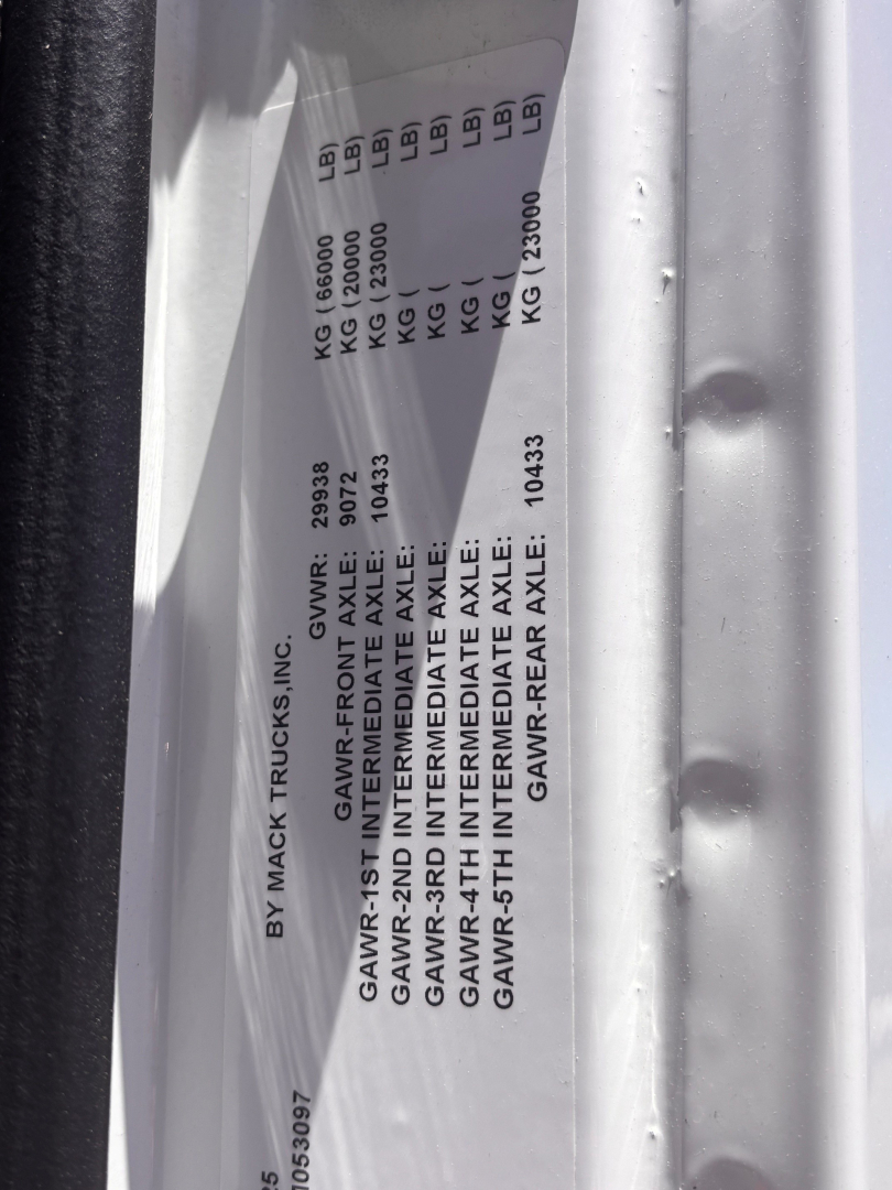Vehicle specs plate on Mack GR64B showing GAWR values: GAWR-2ND INTERMEDIATE AXLE, GAWR-4TH INTERMEDIATE AXLE, GAWR-REAR AXLE, etc.