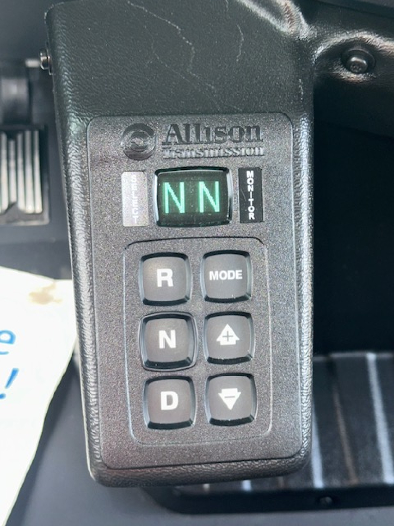 Dashboard gear selector panel showing Allison transmission with NN indicator in green and surrounding buttons including R, N, D, Mode, up and down arrows.