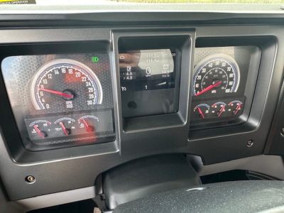 Dashboard of 2025 Mack MD7 showing instrument cluster with speedometer, tachometer, fuel gauges, and a central digital display.