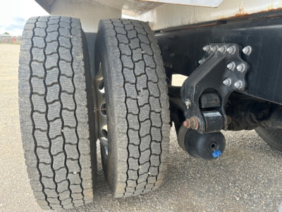 Wheel pair showing dual rear tires on Mack MD7 chassis with suspension and mounting hardware.