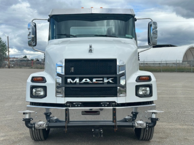 Mack MD7 front view showing bold grille with MAC K letters, large rectangular headlights, chrome bumper, and towing hooks.
