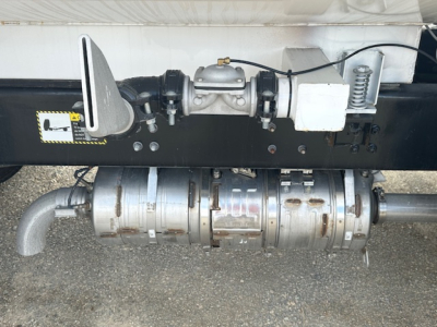 Truck underside showing fuel system components and drive shaft for a 2025 Mack MD7, with a visible PTO pump and hoses.