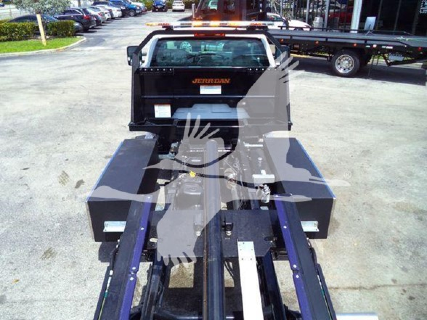 New 2023 Chevrolet Silverado 6500HD rollback bed showing Cummins/Proprietary powertrain area and flatbed with storage boxes.