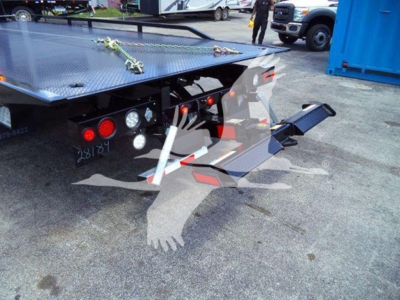 Truck rollback bed rear with platform and hydraulic wheel lift, taillights, and metal work surface; part of a 2023 Chevrolet Silverado 6500HD listing.