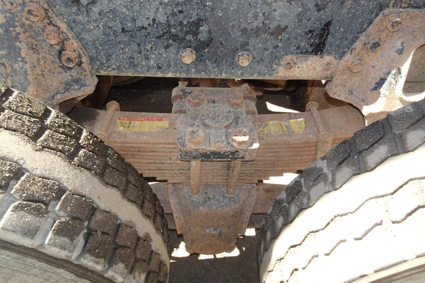 Front view undercarriage of a 1986 Peterbilt 359 dump truck showing the differential and rear axle housing with dual tires.