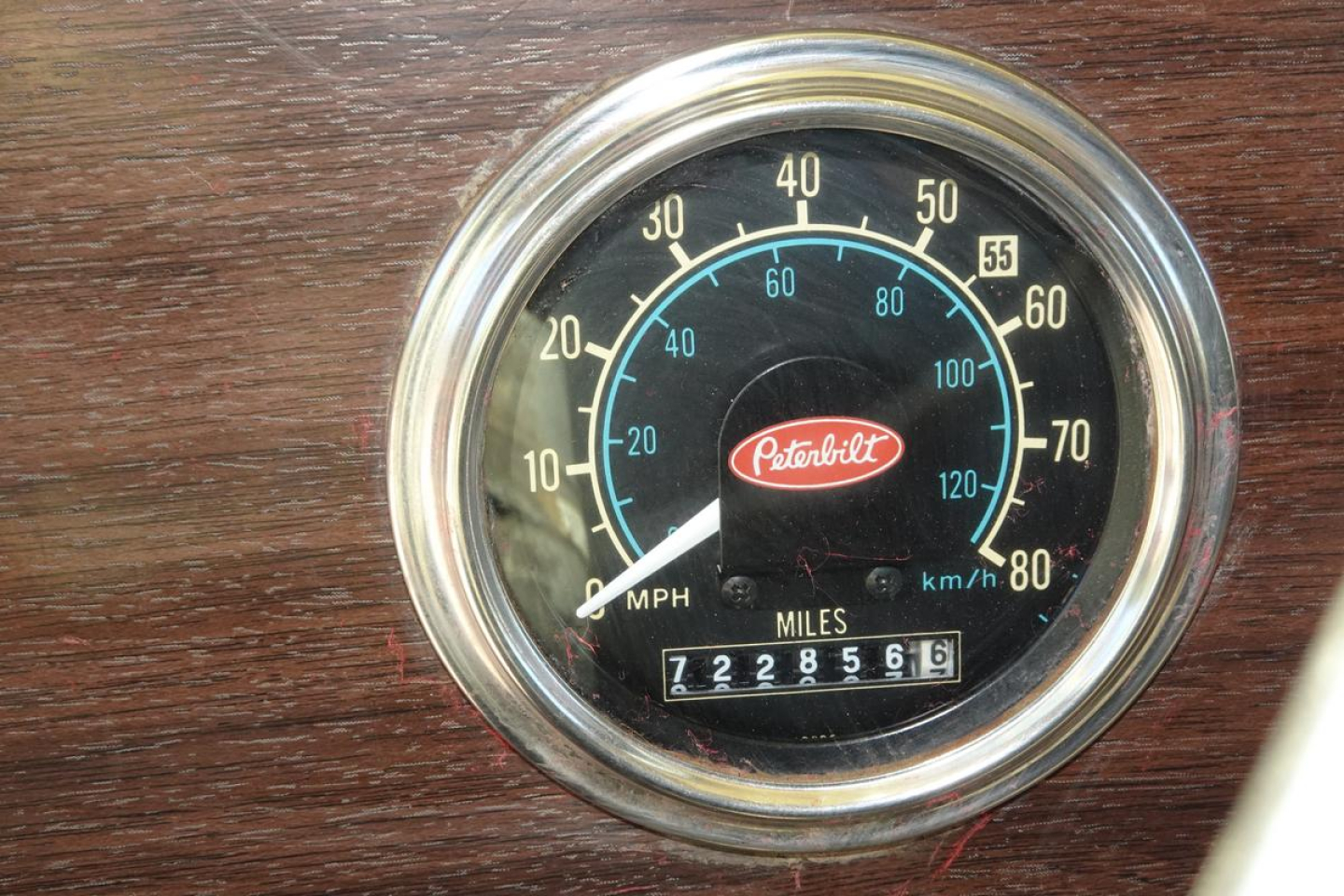 Peterbilt dashboard speedometer showing analog gauge with MPH and KMH scales, Peterbilt logo at center, odometer reading 722,856 miles.