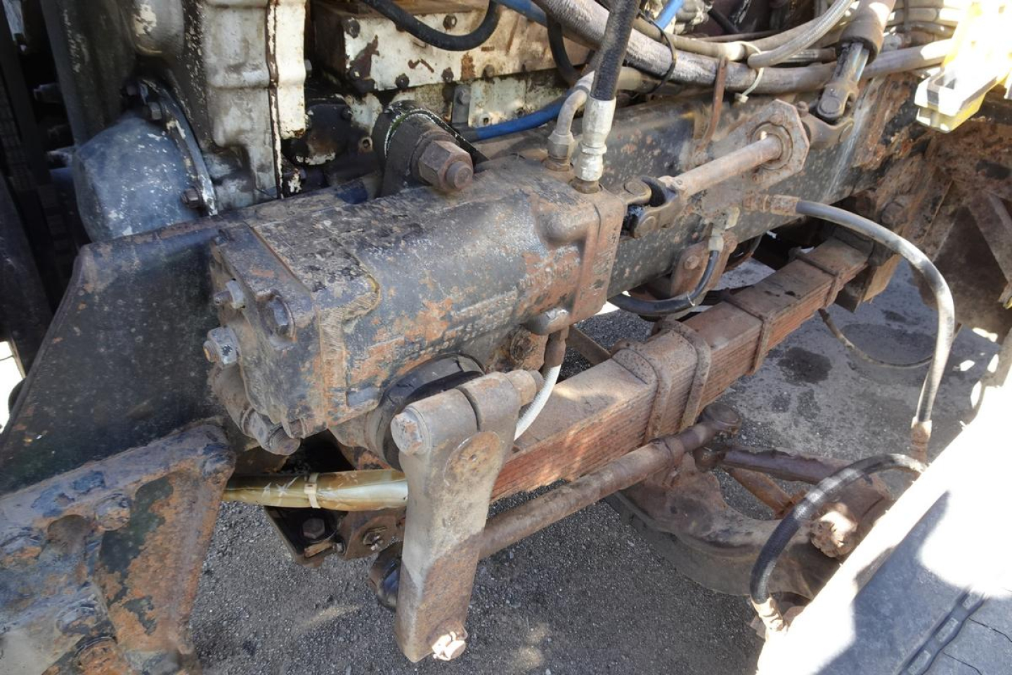 Peterbilt 359 diesel engine bay showing exposed exhaust manifold and drivetrain components in in-service condition.