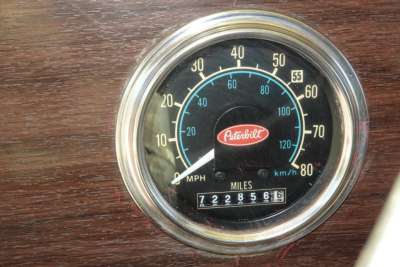 Peterbilt dashboard speedometer showing analog gauge with MPH and KMH scales, Peterbilt logo at center, odometer reading 722,856 miles.